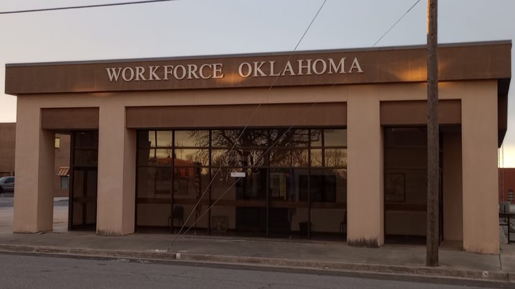 Glass front with tan pillars. Workforce Oklahoma across the top of the building.